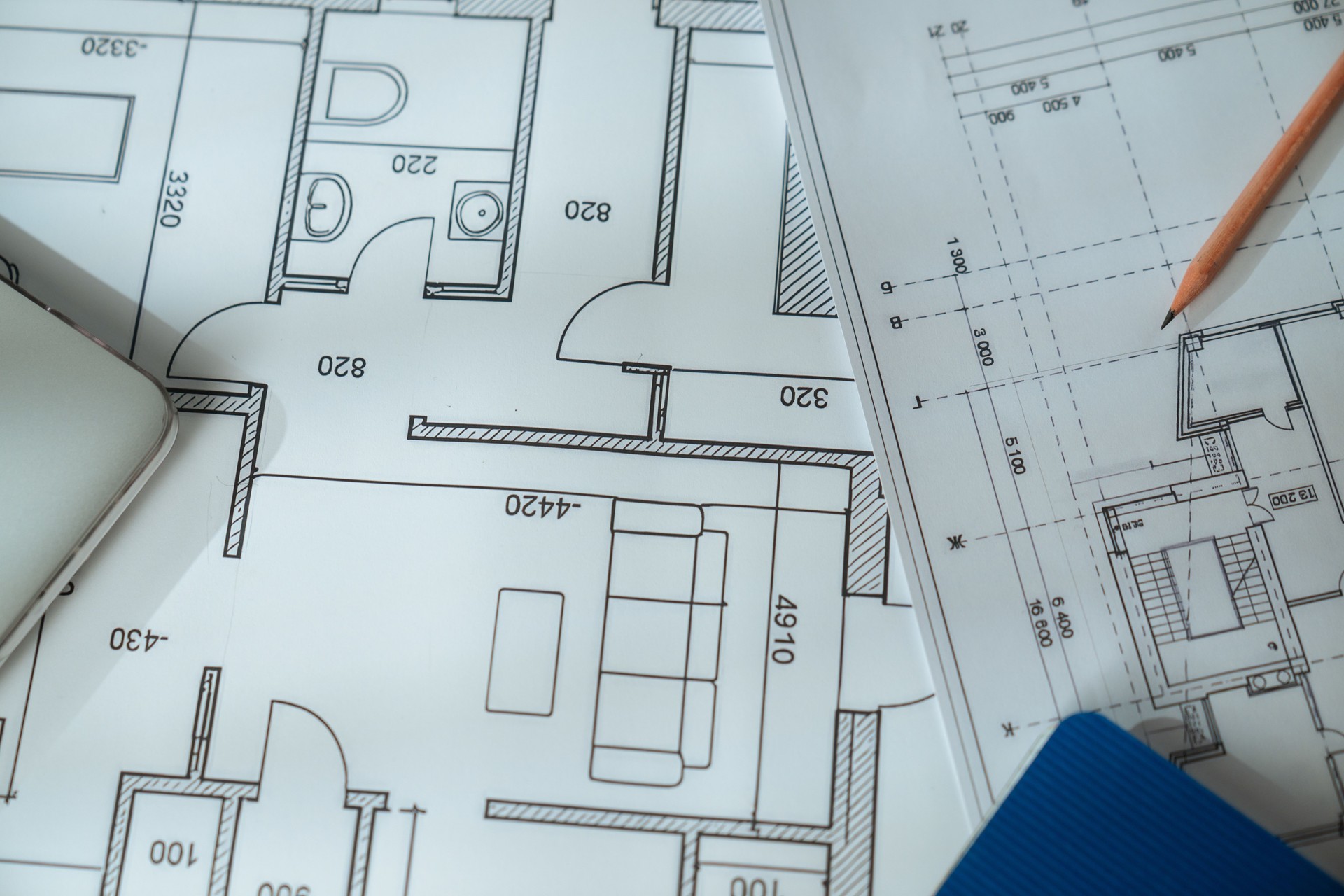 Architectural Blueprint with Wooden Ruler on Table